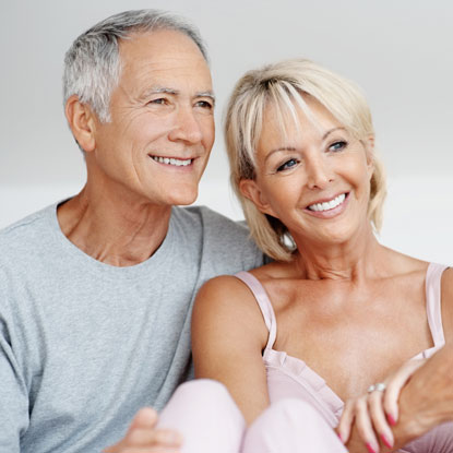 happy couple smiling with metal free implants